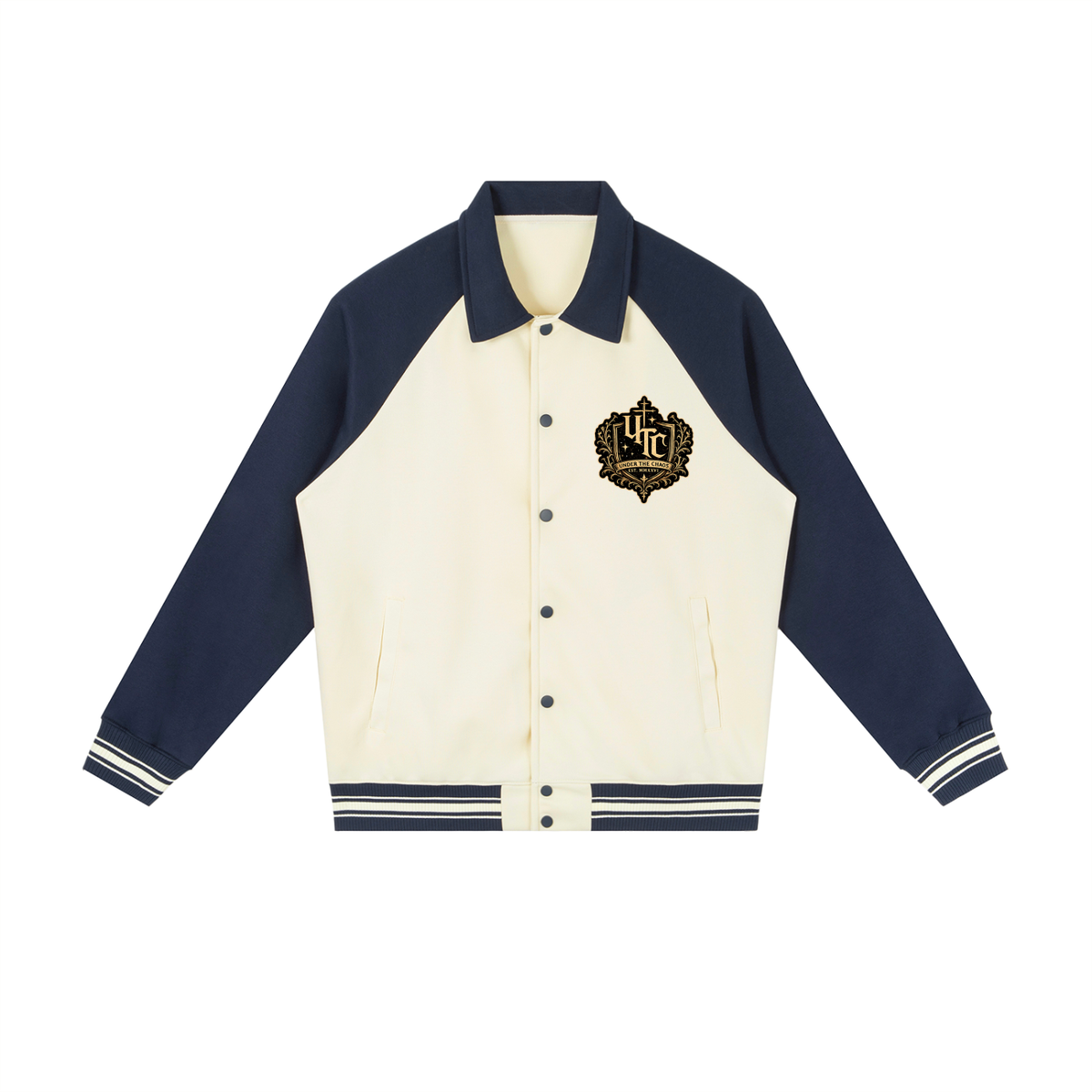 A varsity-style jacket with cream-colored body panels and navy blue sleeves, collar, and ribbed trim. The jacket features embroidered patches on the chest, including a circular black-and-white patch and a small airplane patch, set against a plain white background.